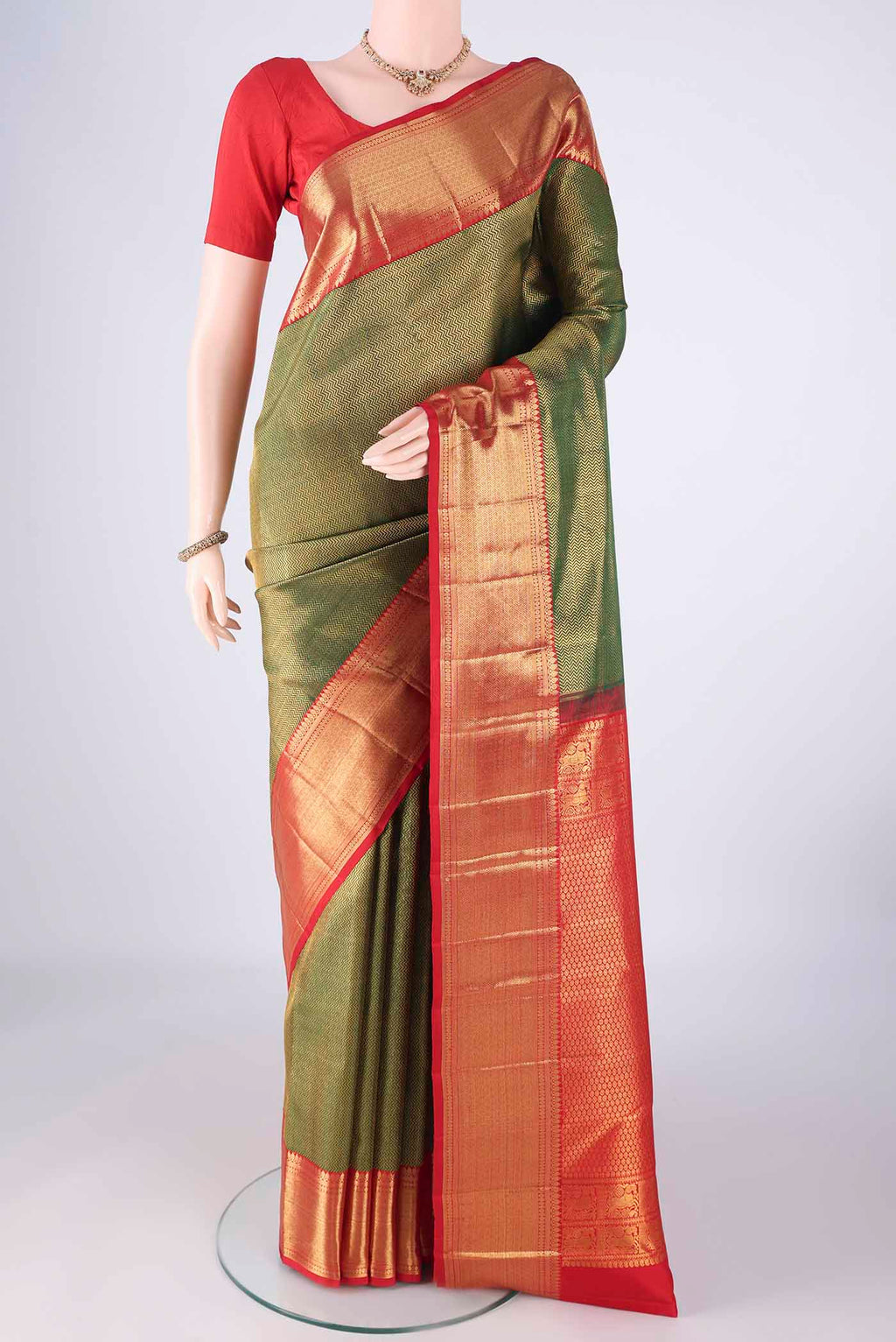 Bottle Green Kanchipuram Silk Saree with Zari Brocade on the body and Zari Border.  displayed on a mannequin