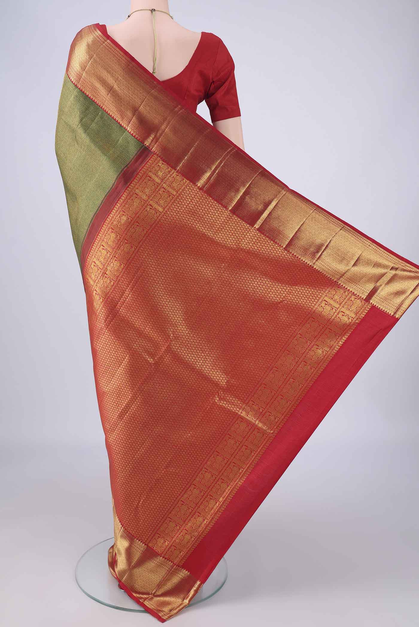 Flat view of Bottle Green Kanchipuram Silk Saree with Zari Brocade on the body and Zari Border. 