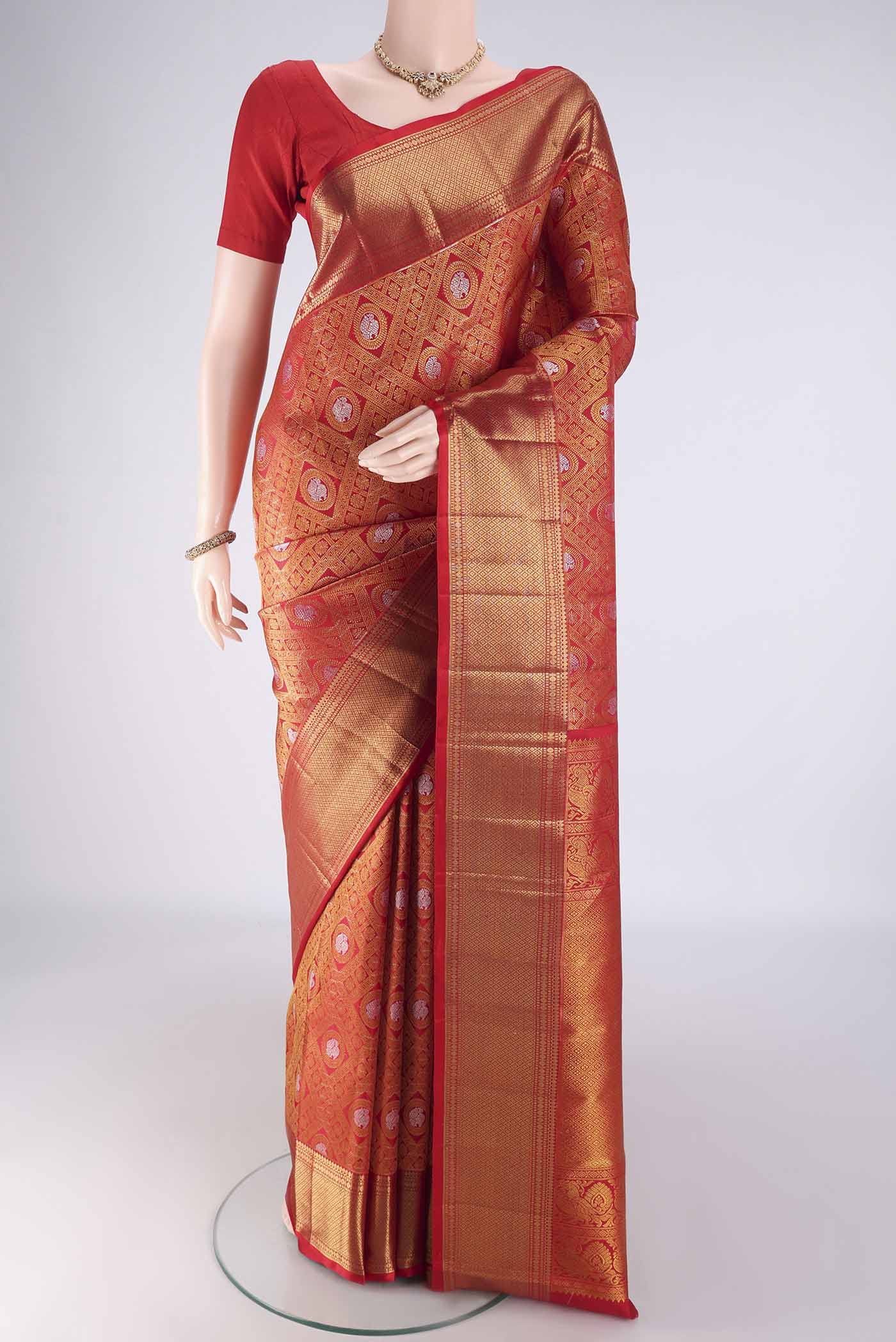 Red Kanchipuram Silk Saree with Zari Brocade on the body and Zari Border.  displayed on a mannequin