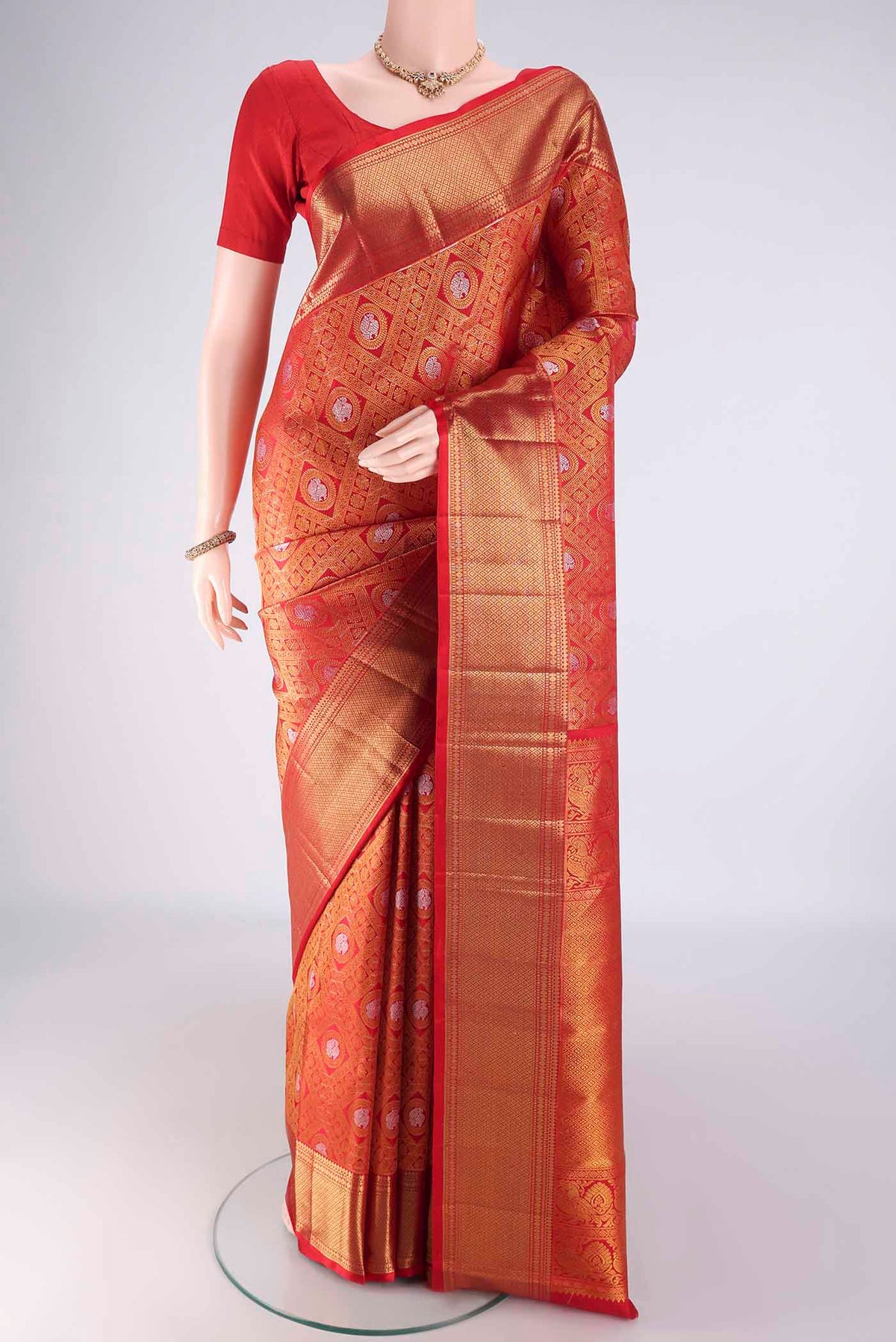 Red Kanchipuram Silk Saree with Zari Brocade on the body and Zari Border.  displayed on a mannequin