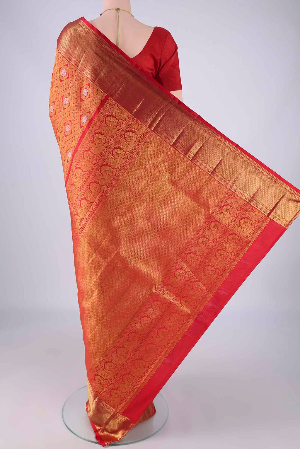 Flat view of Red Kanchipuram Silk Saree with Zari Brocade on the body and Zari Border. 