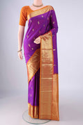 Purple Kanchipuram Silk Saree with Zari Butta on the body and Zari Border.  displayed on a mannequin