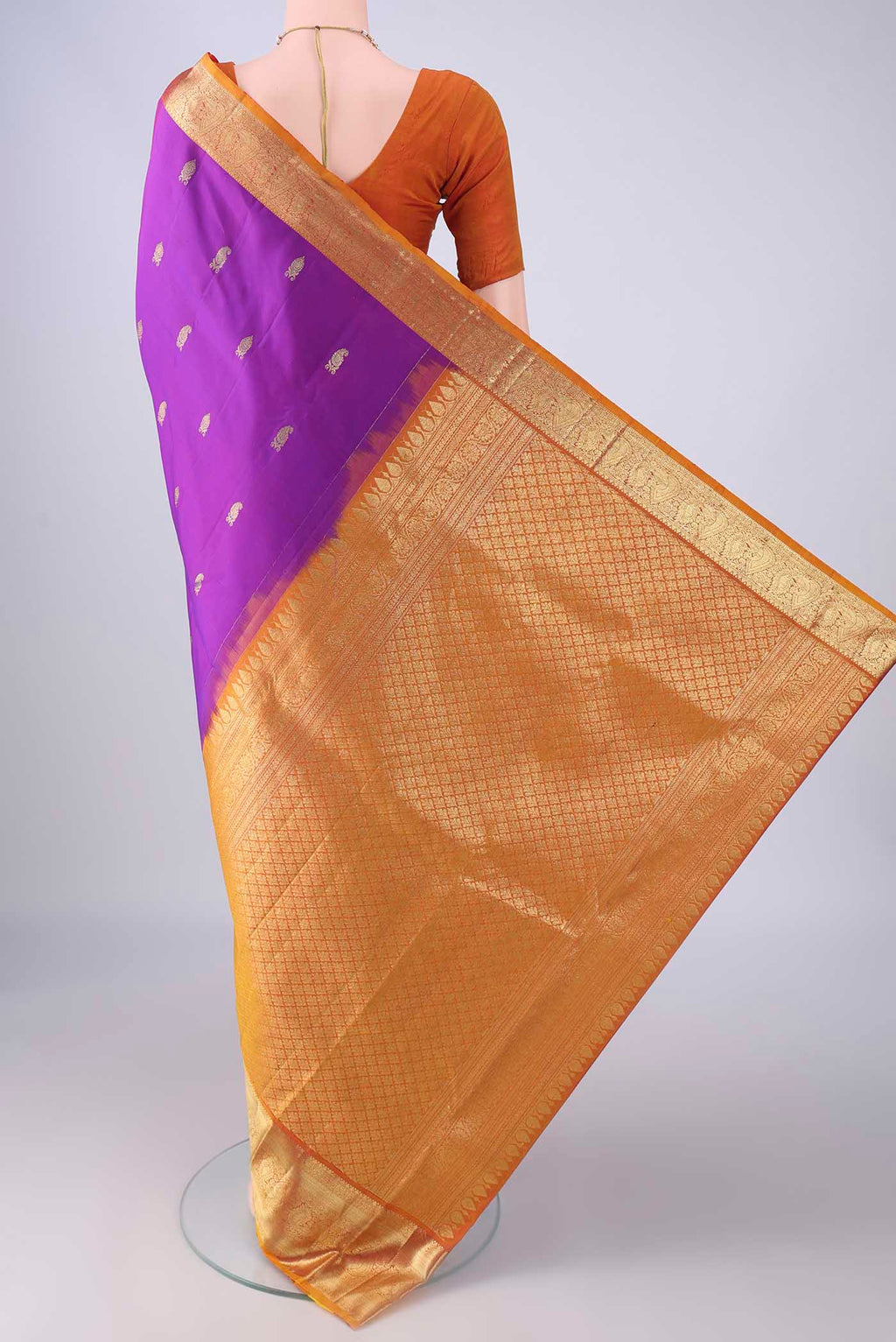 Flat view of Purple Kanchipuram Silk Saree with Zari Butta on the body and Zari Border. 