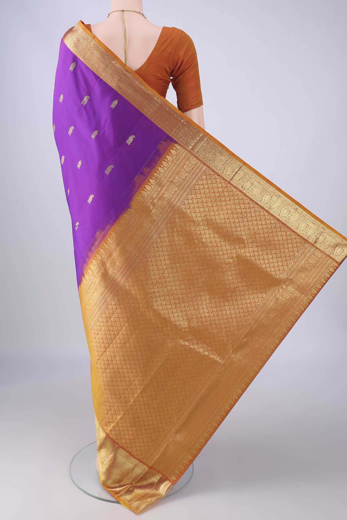 Flat view of Purple Kanchipuram Silk Saree with Zari Butta on the body and Zari Border. 