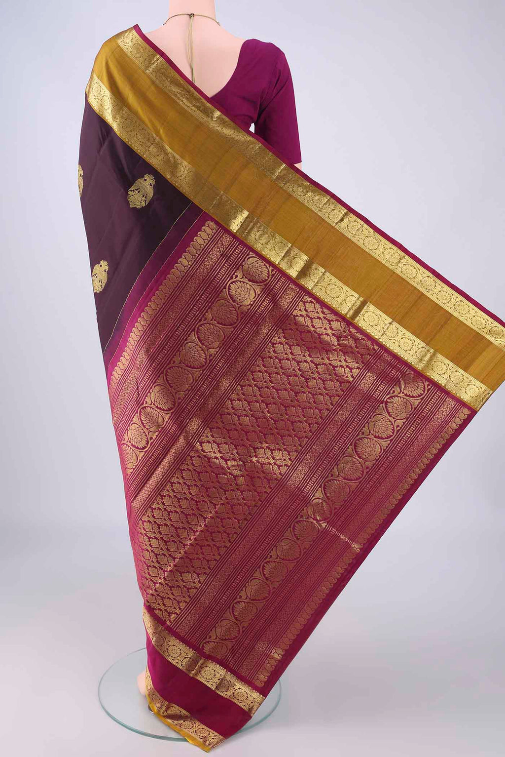 Flat view of Burgundy Kanchipuram Silk Saree with Zari Butta on the body and Ganga Jamuna Border. 