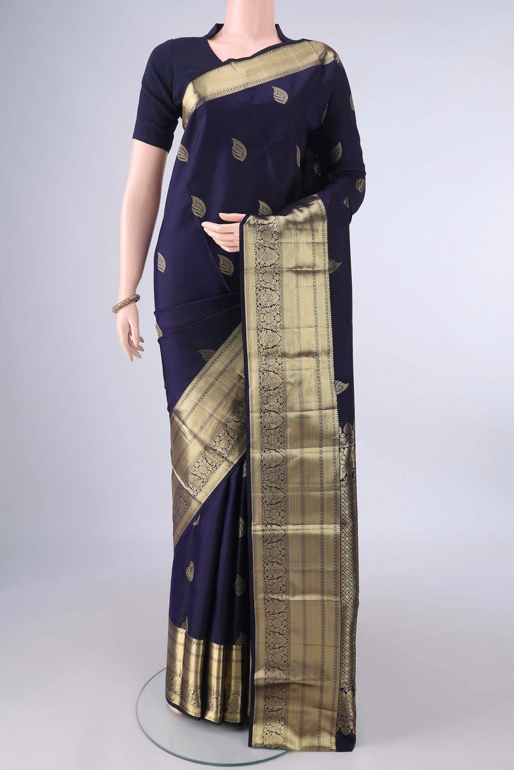 Pure Silk Navy Blue Kanjivaram Saree with Zari Butta on the body and Zari Border.  displayed on a mannequin