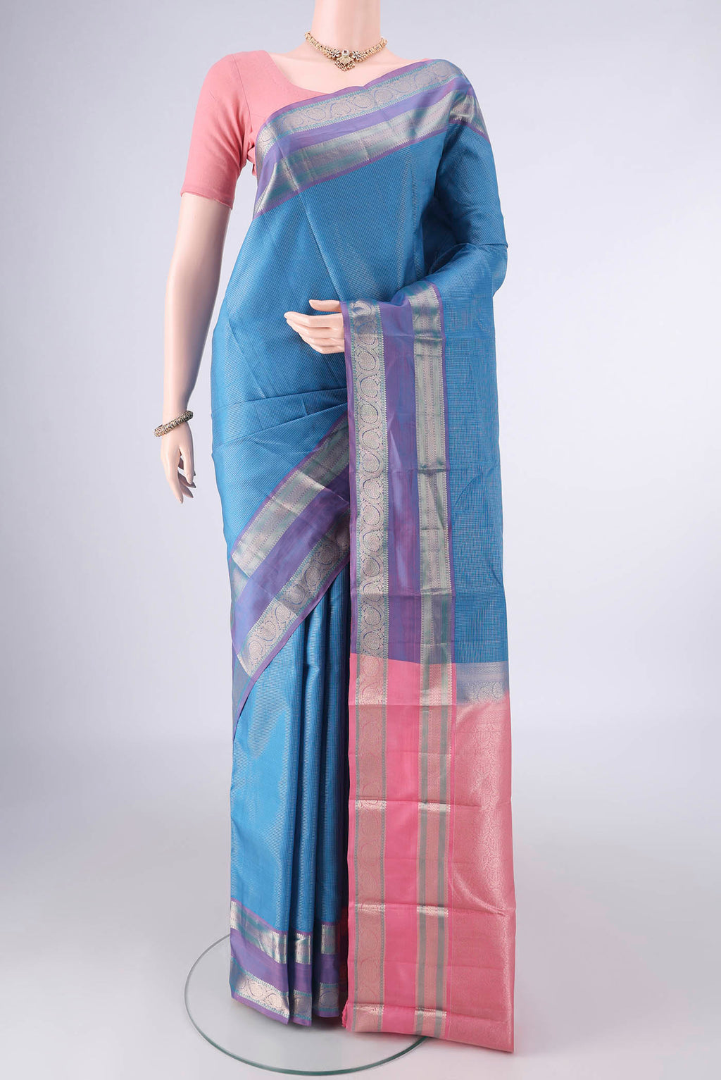 Pure Silk Blue Kanjivaram Saree with Checked design on the body and Zari Border.  displayed on a mannequin