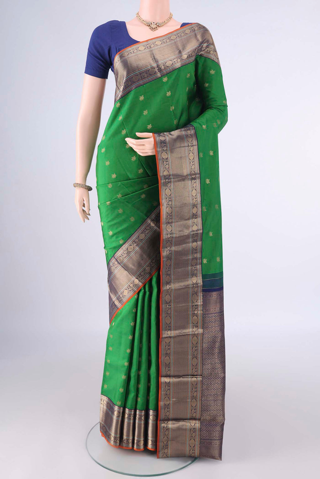 Pure Silk Green Kanchipuram Saree with Zari Butta on the body and Zari Border.  displayed on a mannequin