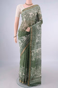 Light Green Maheshwari Cotton Saree with Batik Print on the body and Zari Border.  displayed on a mannequin