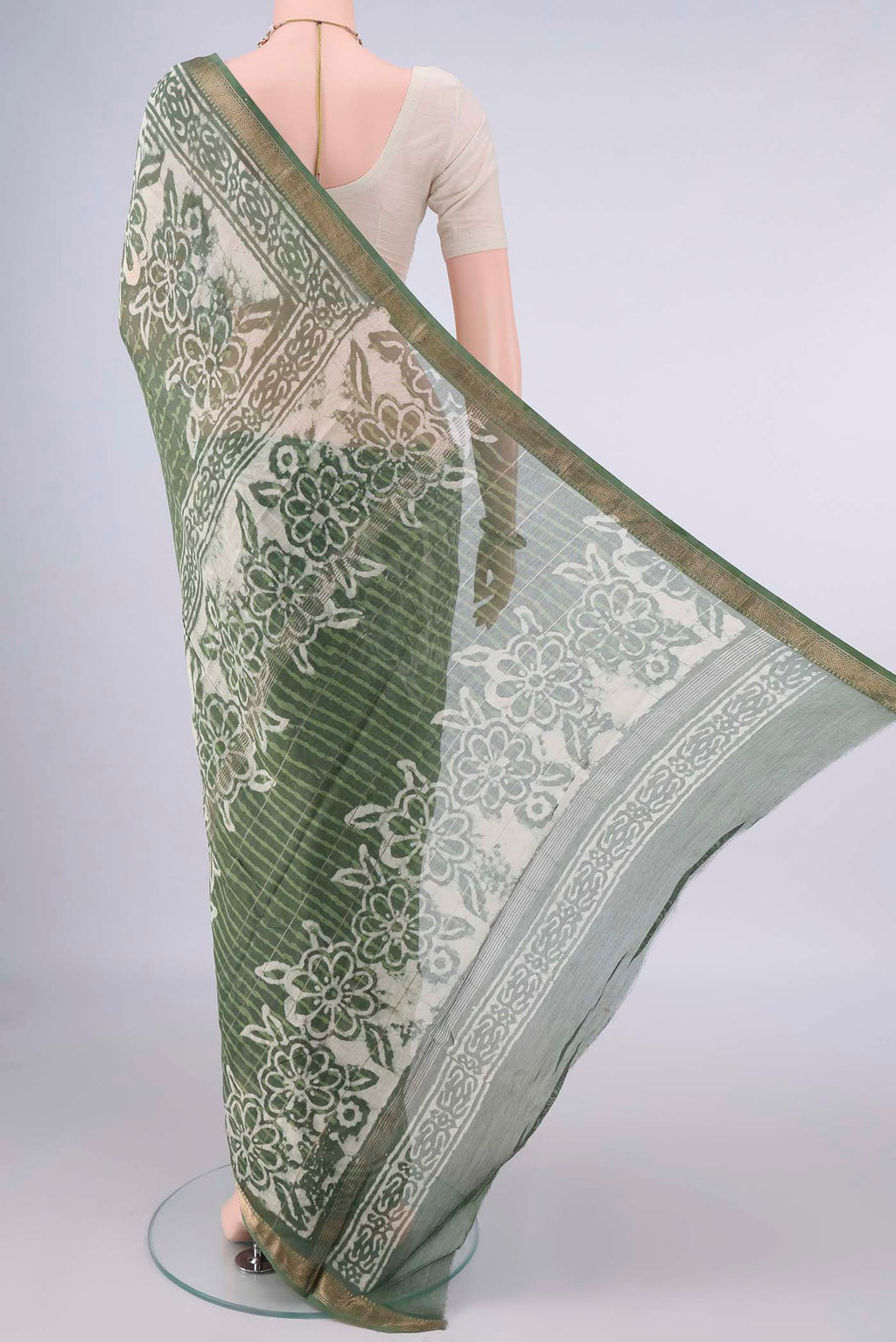 Flat view of Light Green Maheshwari Cotton Saree with Batik Print on the body and Zari Border. 