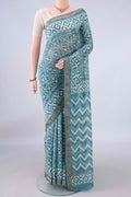 Maya Blue Maheshwari Cotton Saree with Batik Print on the body and Zari Border.  displayed on a mannequin