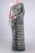 Grey Chanderi Cotton Saree with Batik Print on the body and Thin Zari Line.  displayed on a mannequin