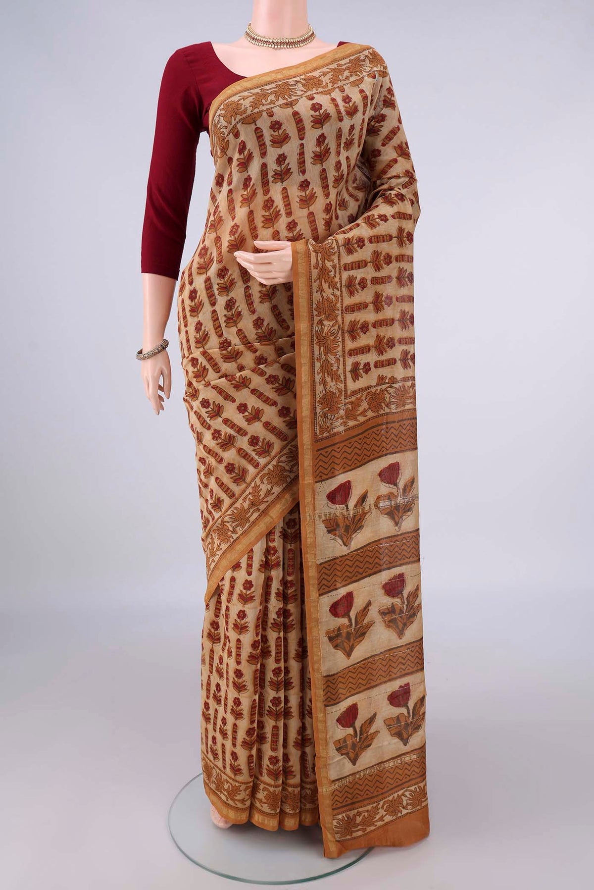 Dark Beige Chanderi Cotton Saree with Batik Print on the body and Thin Zari Line.  displayed on a mannequin