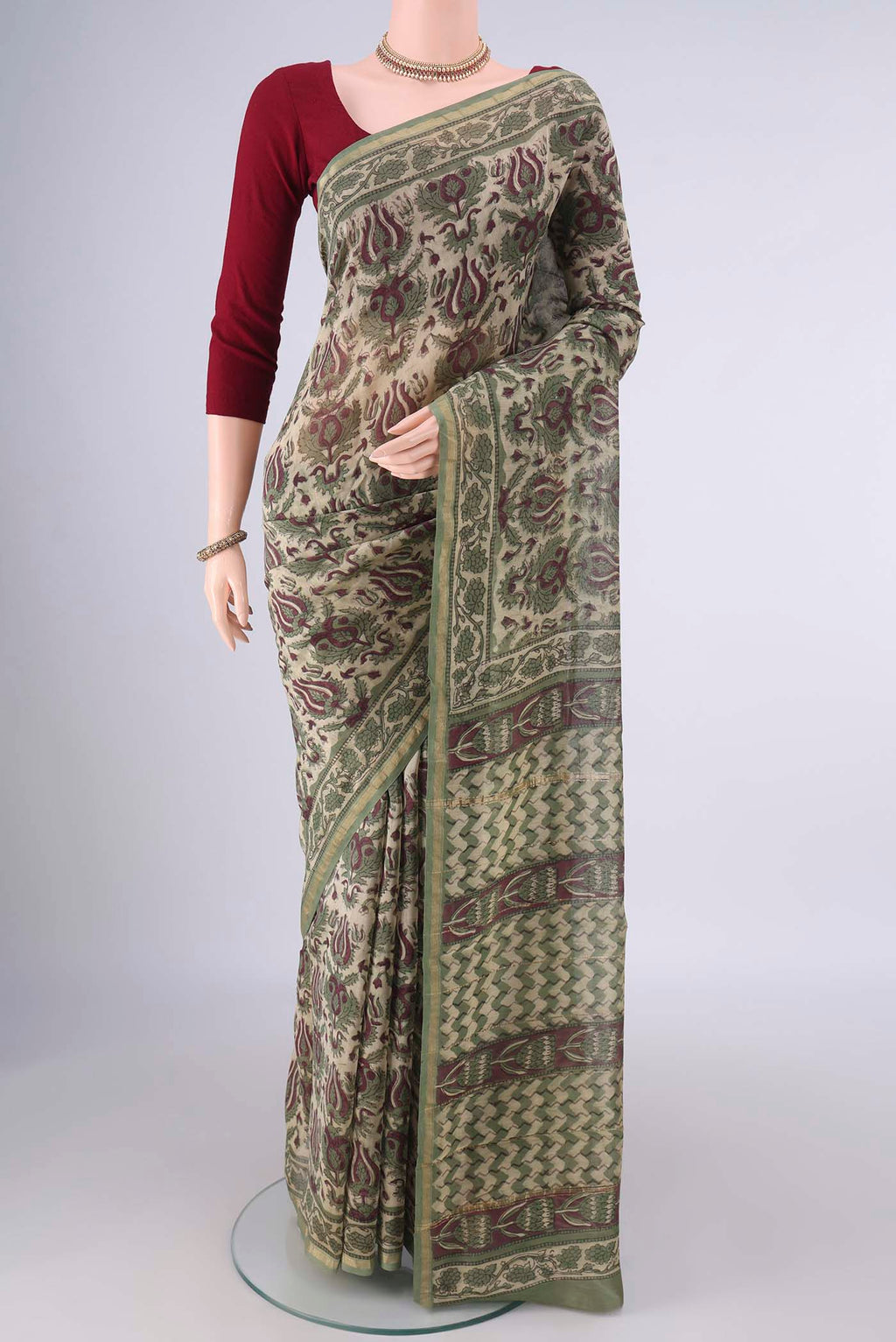 Beige Chanderi Cotton Saree with Batik Print on the body and Zari Border.  displayed on a mannequin