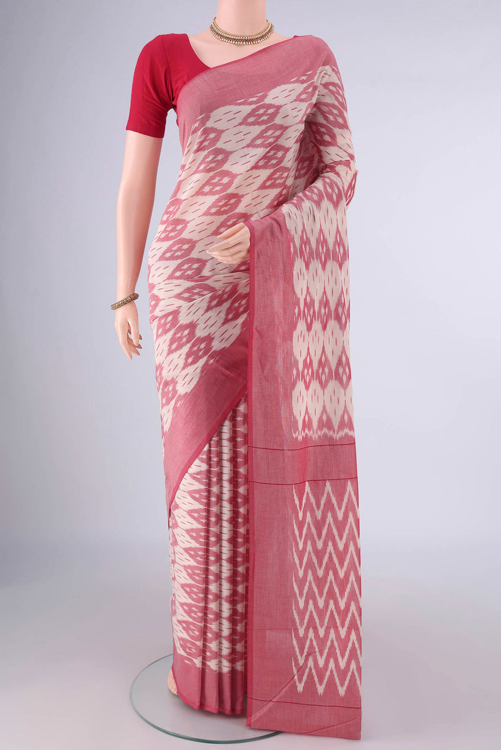 Off White Pochampally Cotton Saree with Ikat design on the body and Plain Border.  displayed on a mannequin