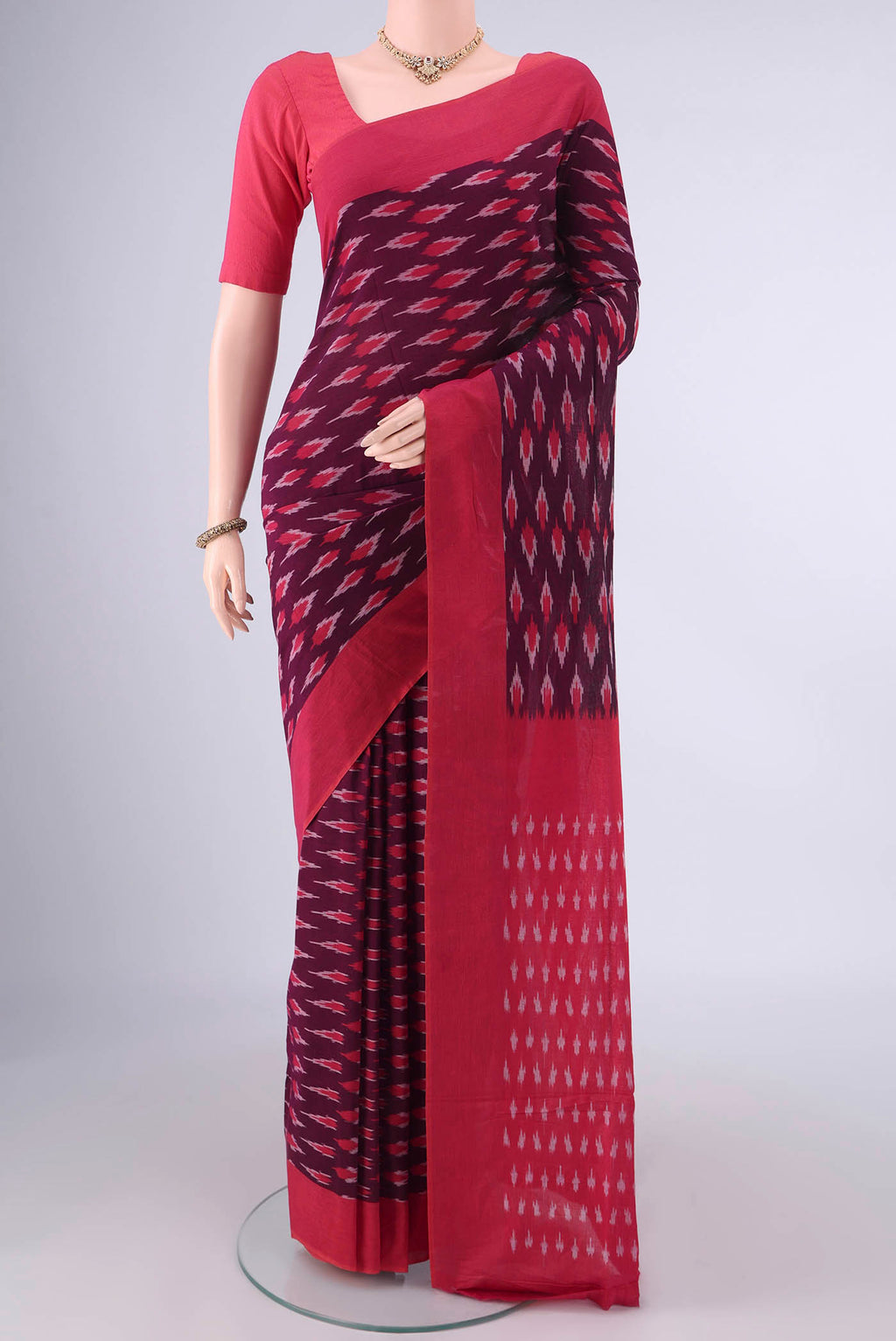 Magenta Pochampally Cotton Saree with Ikat design on the body and Plain Border.  displayed on a mannequin