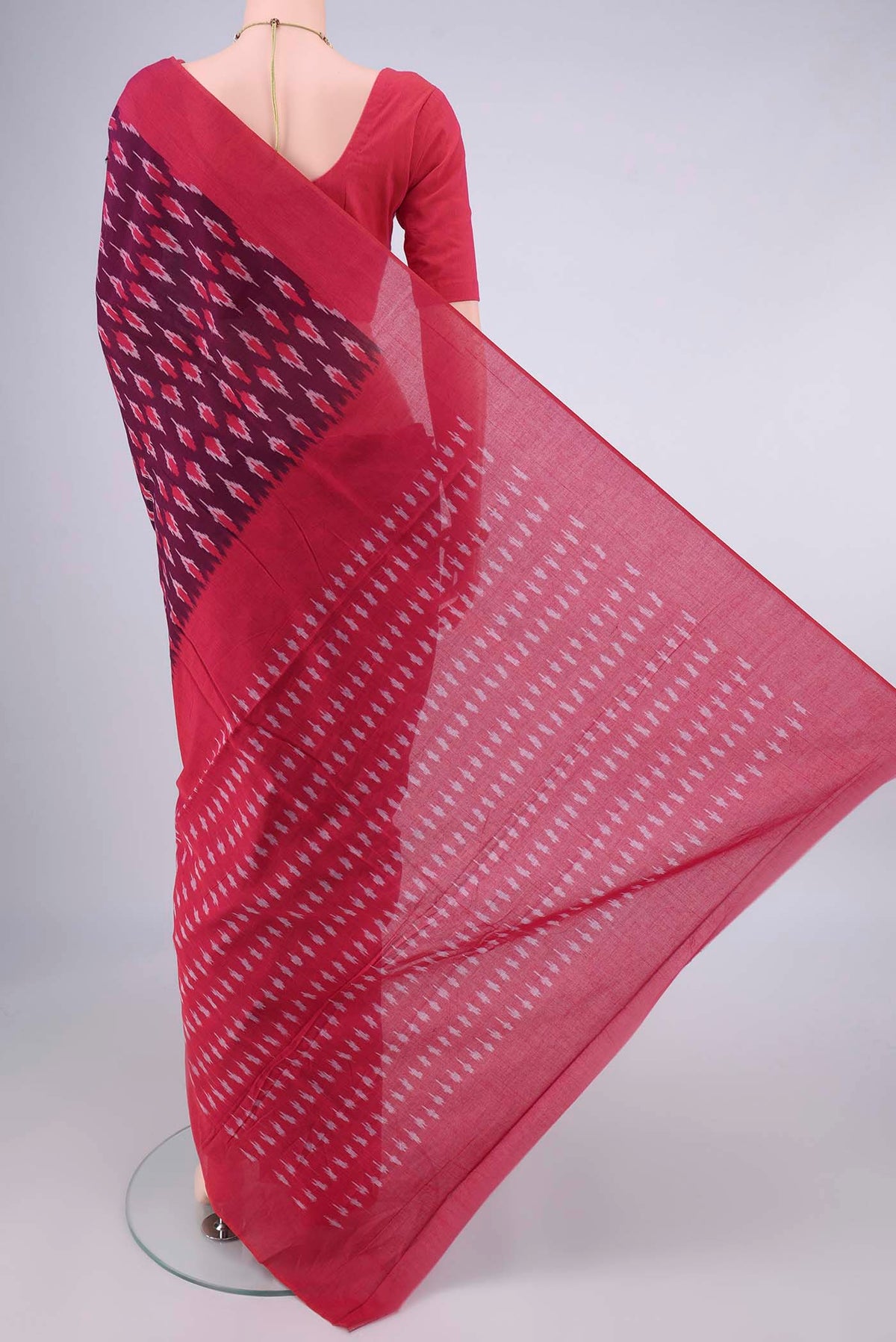 Flat view of Magenta Pochampally Cotton Saree with Ikat design on the body and Plain Border. 