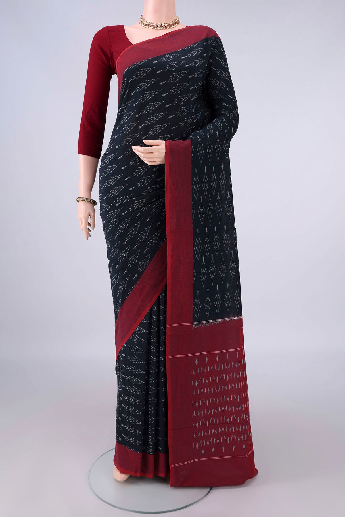Black Pochampally Cotton Saree with Ikat design on the body and Ikat Border.  displayed on a mannequin