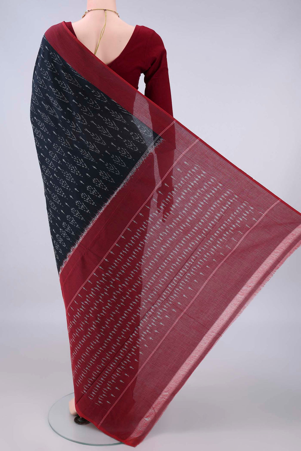 Flat view of Black Pochampally Cotton Saree with Ikat design on the body and Ikat Border. 