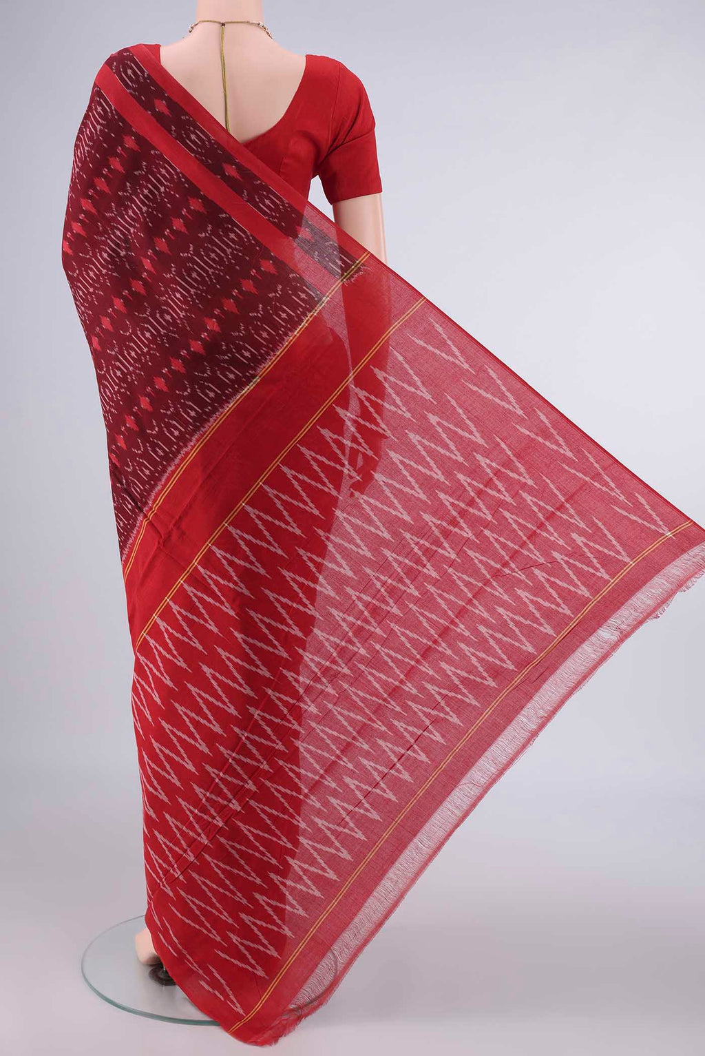 Flat view of Maroon Pochampally Cotton Saree with Ikat design on the body and Ikat Border. 