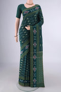 Bottle Green Pochampally Cotton Saree with Ikat design on the body and Ikat Border.  displayed on a mannequin
