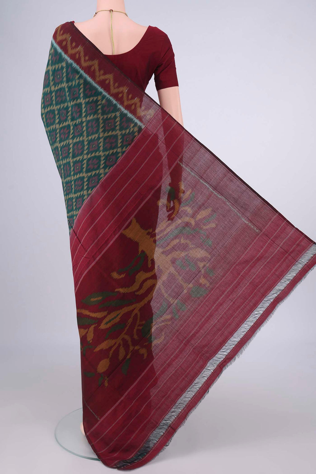 Flat view of Bottle Green Pochampally Cotton Saree with Ikat design on the body and Ikat Border. 