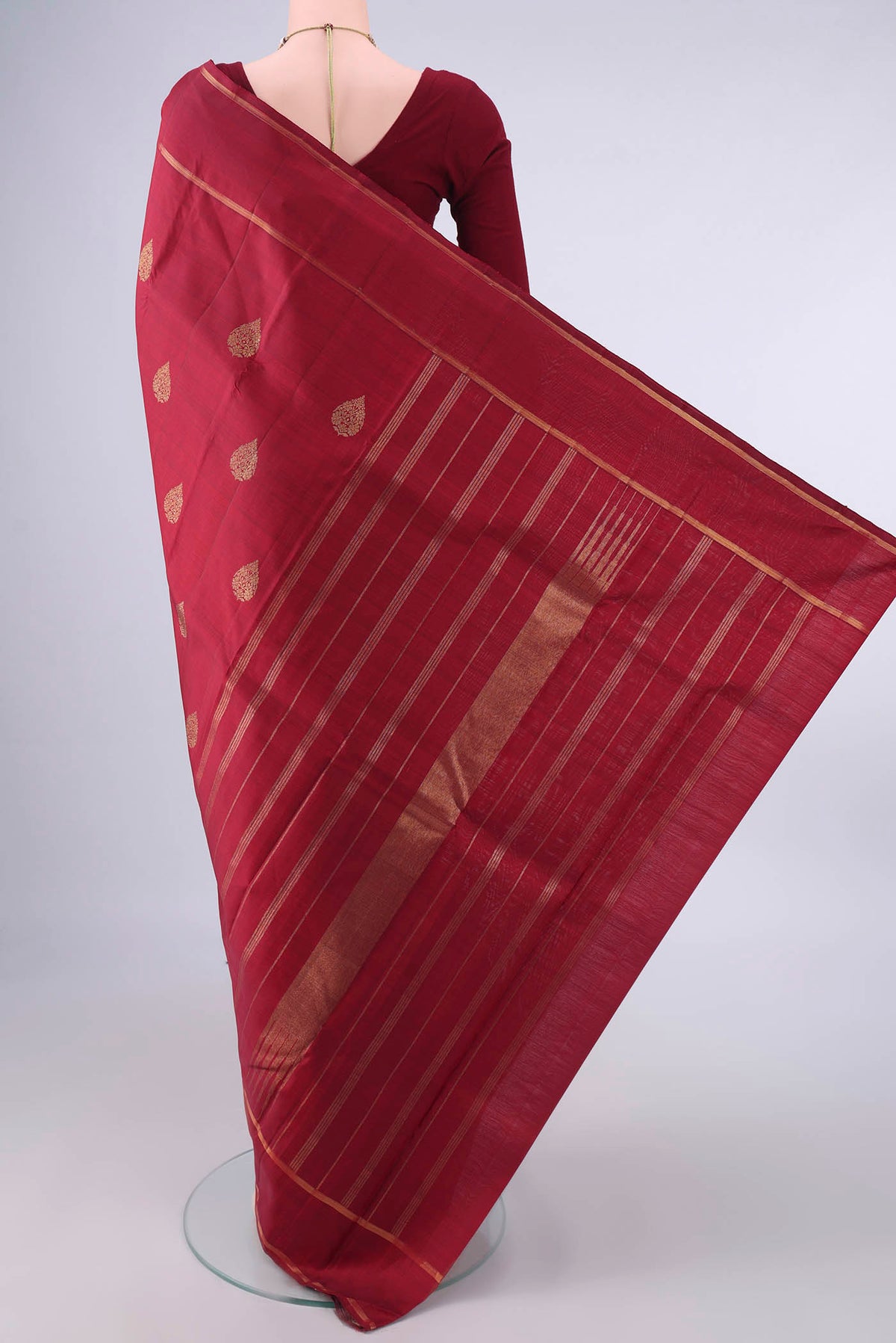 Flat view of Pure Silk Maroon Kanjivaram Saree with Zari Butta on the body and Zari Border. 