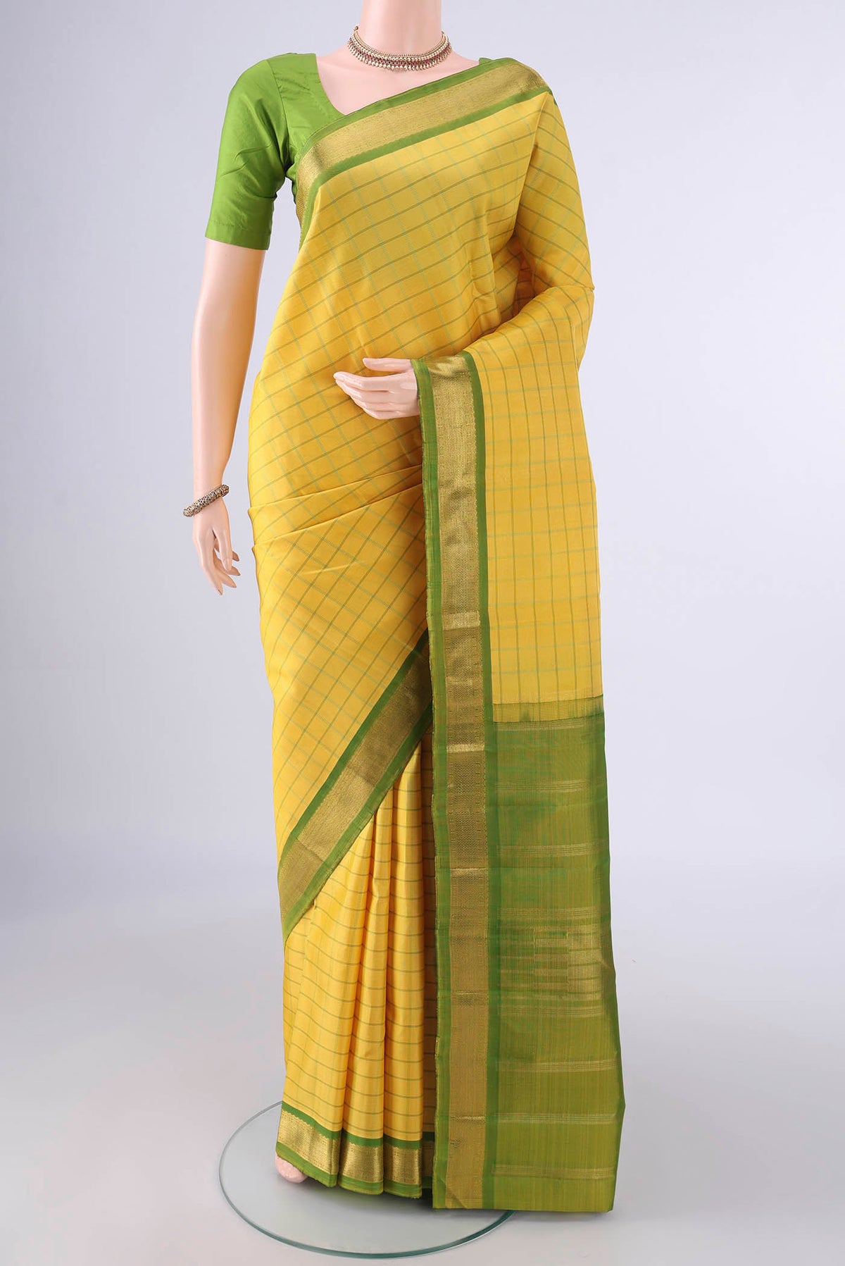Pure Silk Lemon Yellow Kanchipuram Saree with Checked design on the body and Zari Border.  displayed on a mannequin