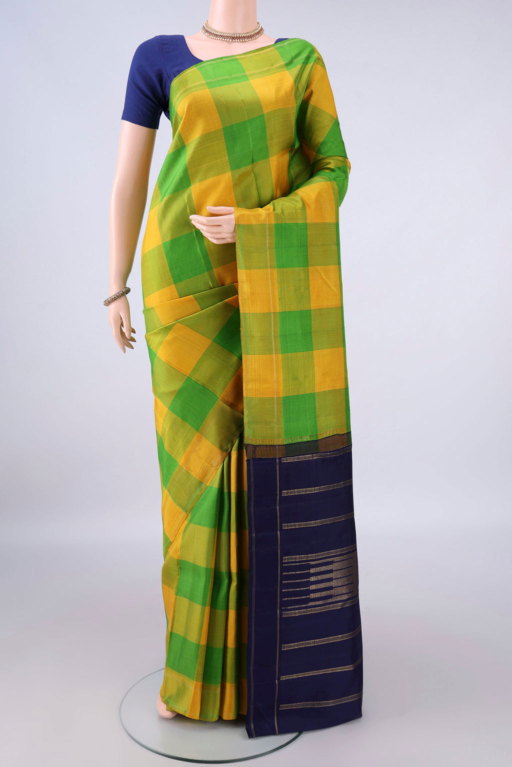 Pure Silk Multi Color Kanjivaram Saree with Checked design on the body and Without Border.  displayed on a mannequin