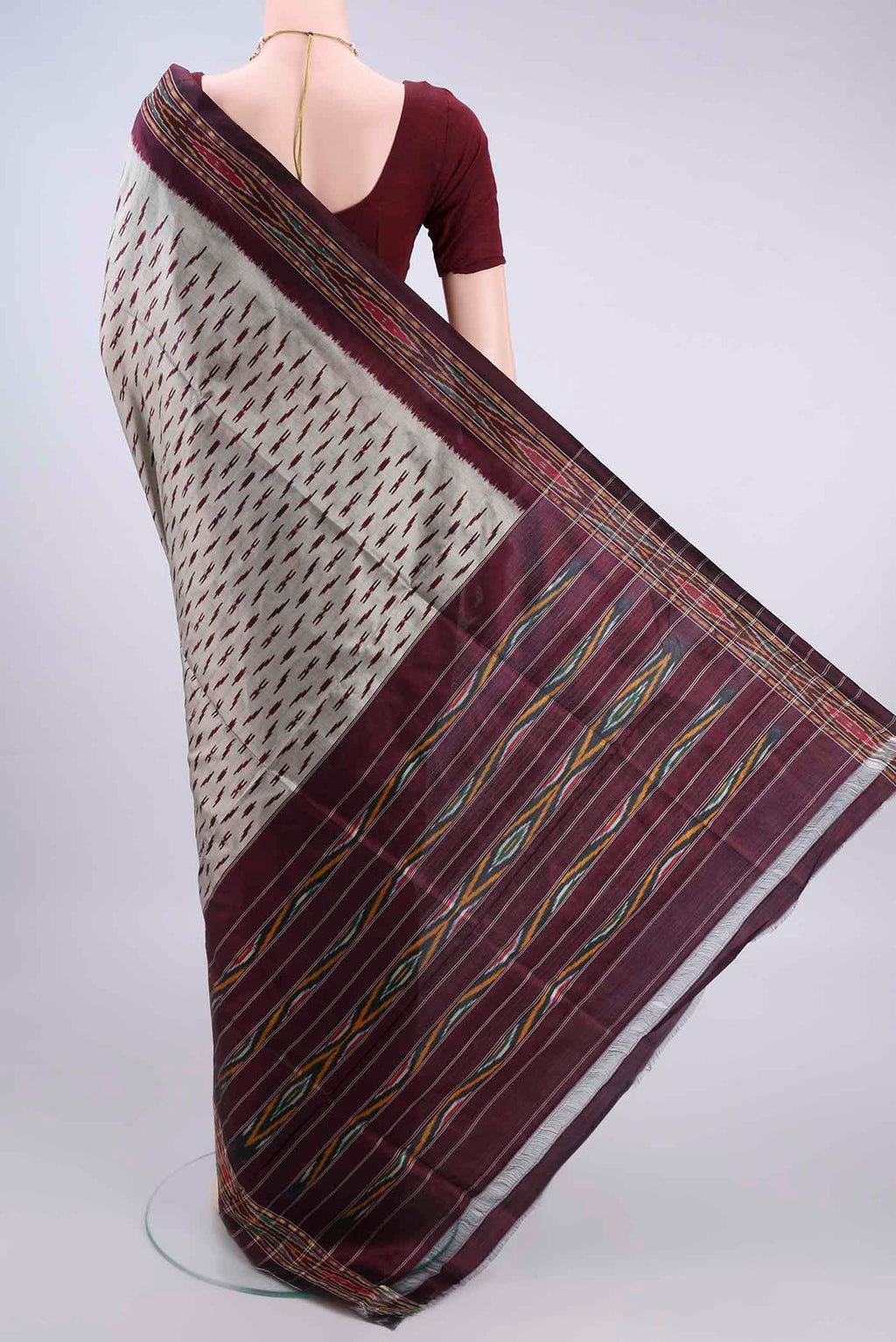 Flat view of Pure Silk Grey Pochampally Saree with Ikat design on the body and Ikat Border. 