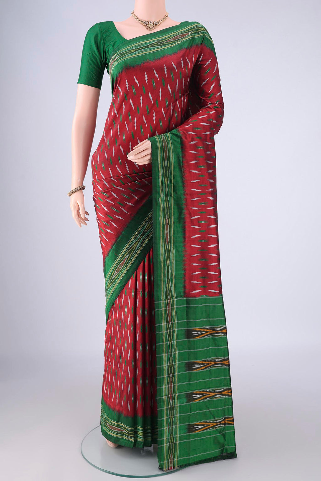 Maroon Pochampally Silk Saree with Pure Ikat on the body and Ikat Border.  displayed on a mannequin
