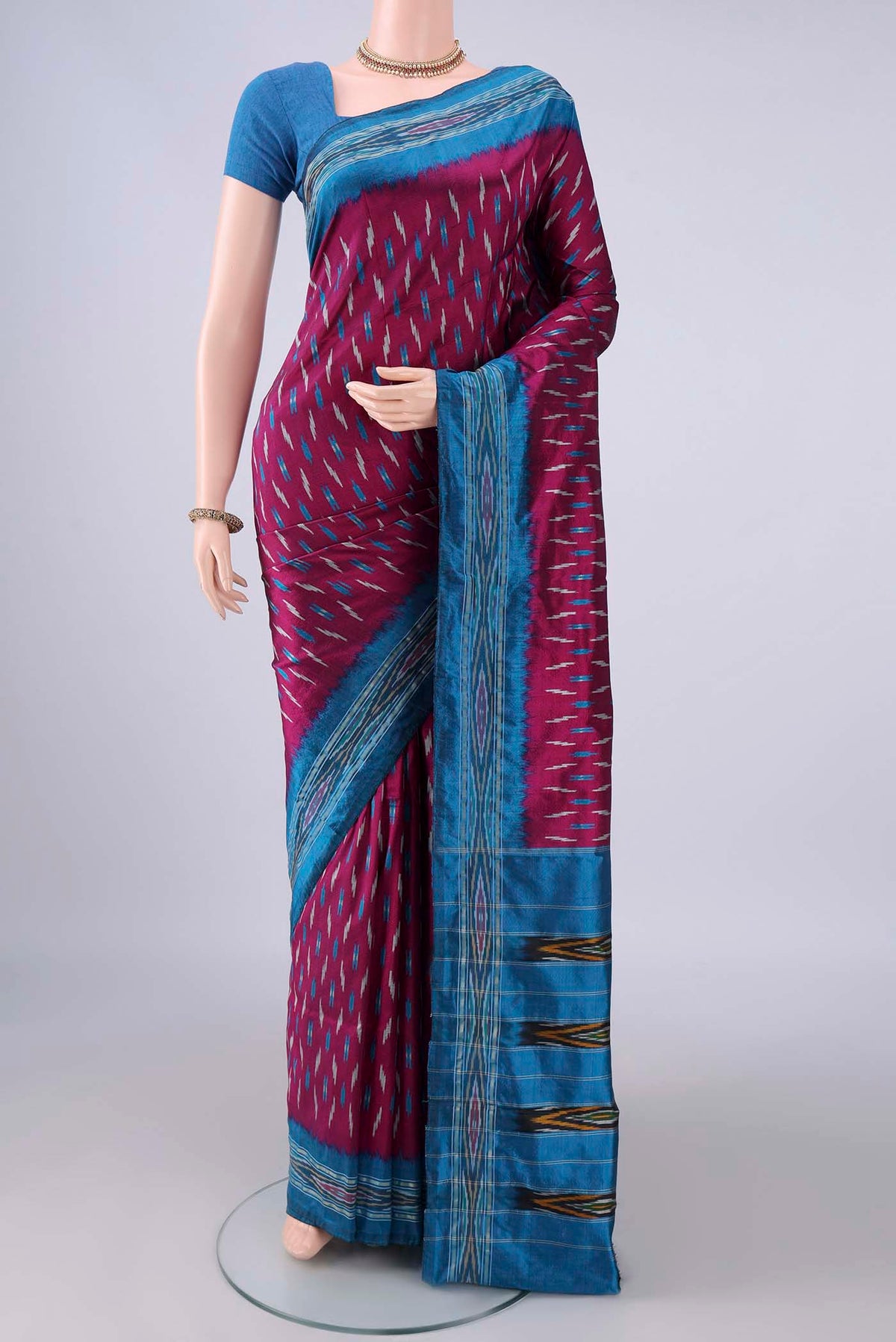 Pure Silk Magenta Pochampally Saree with Pure Ikat on the body and Zari Border.  displayed on a mannequin