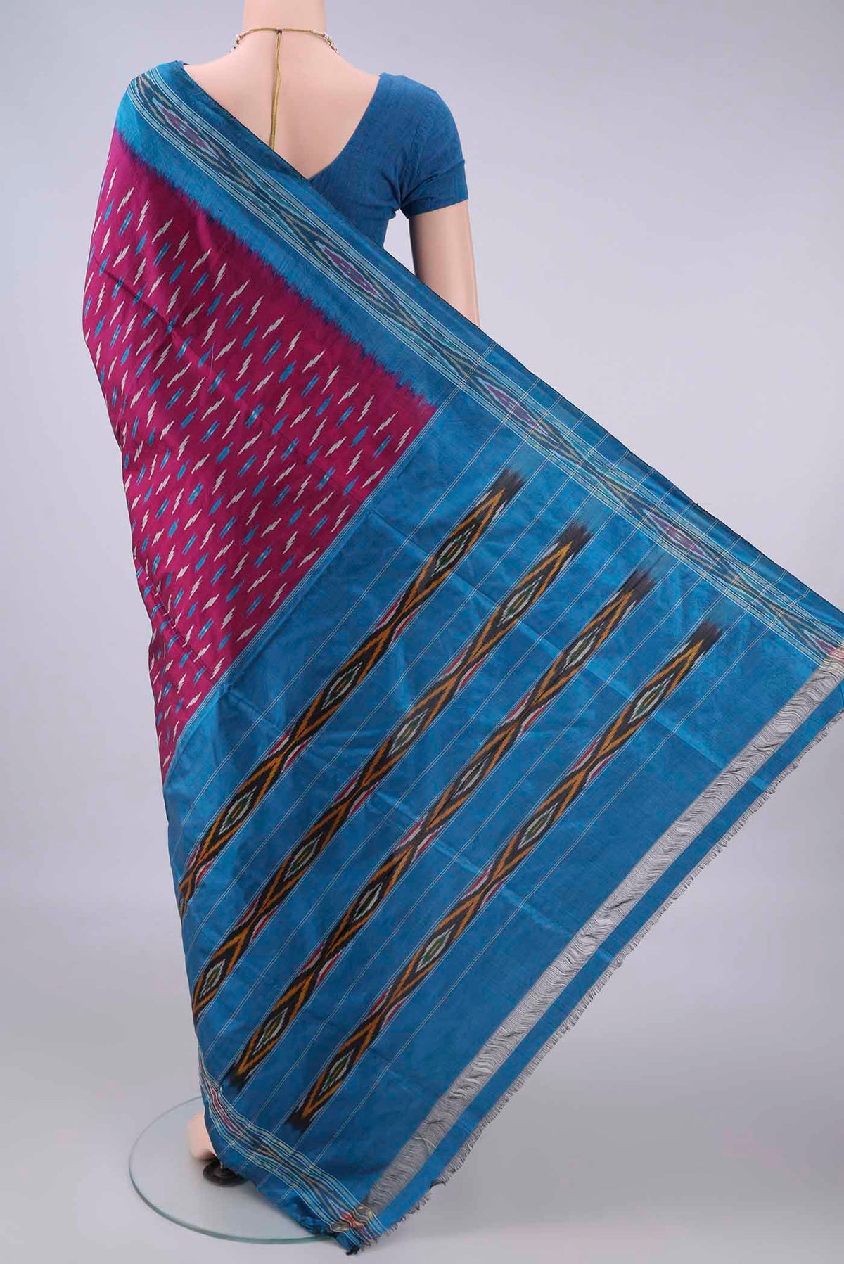 Flat view of Pure Silk Magenta Pochampally Saree with Pure Ikat on the body and Zari Border. 