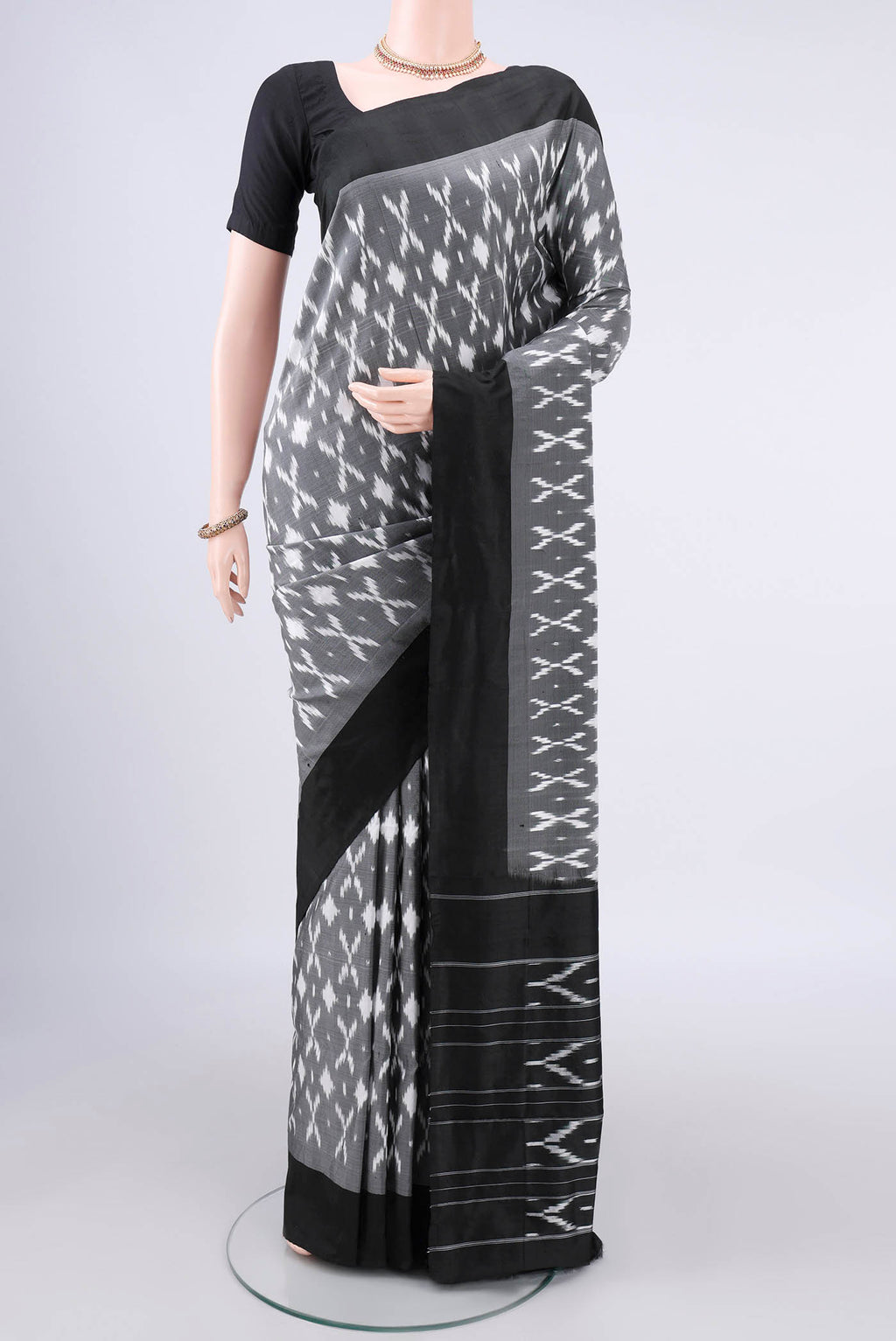 Pure Silk Grey Pochampally Saree with Ikat design on the body and Ikat Border.  displayed on a mannequin