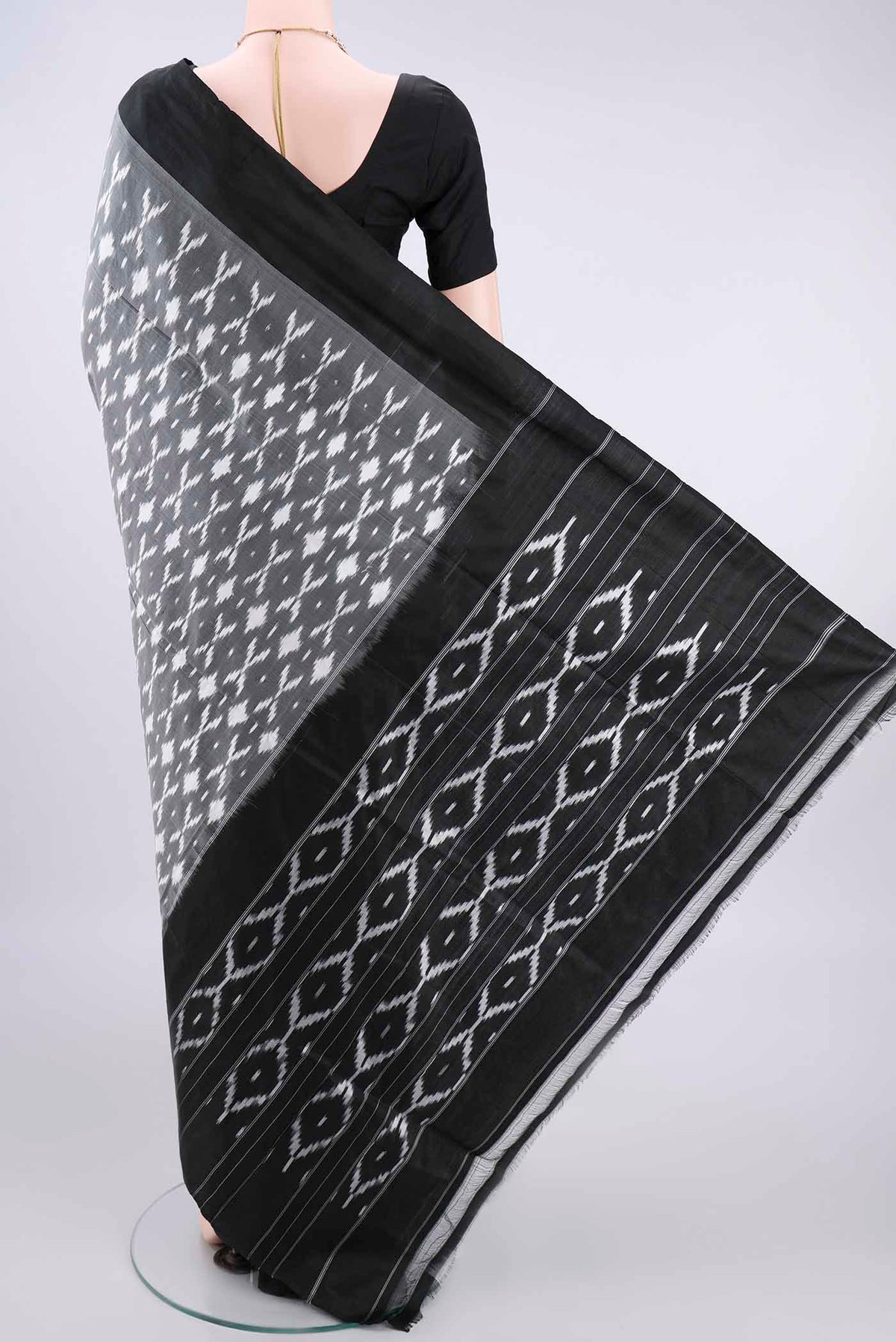 Flat view of Pure Silk Grey Pochampally Saree with Ikat design on the body and Ikat Border. 