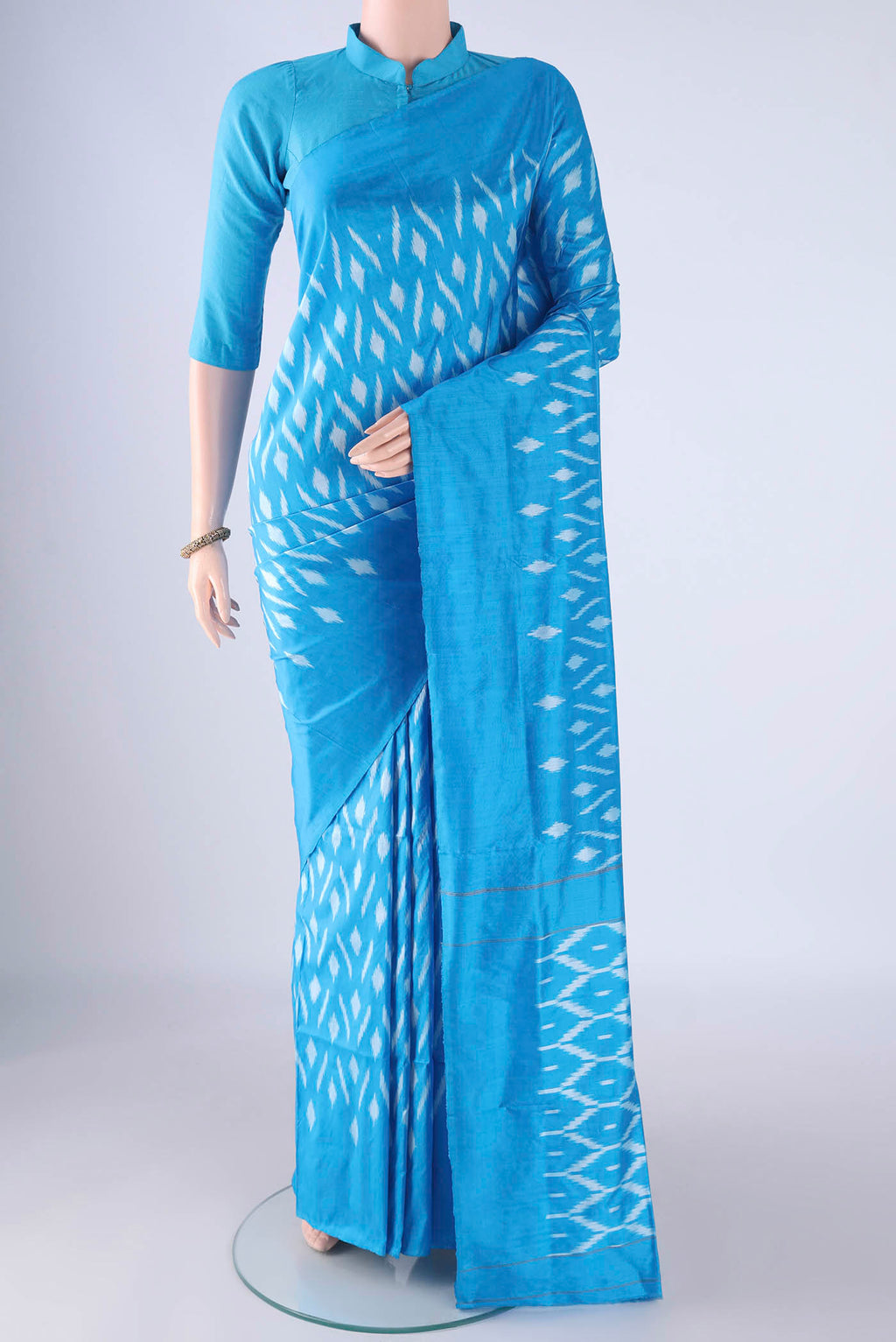 Sky Blue Pochampally Silk Saree with Pure Ikat on the body and Plain Border.  displayed on a mannequin