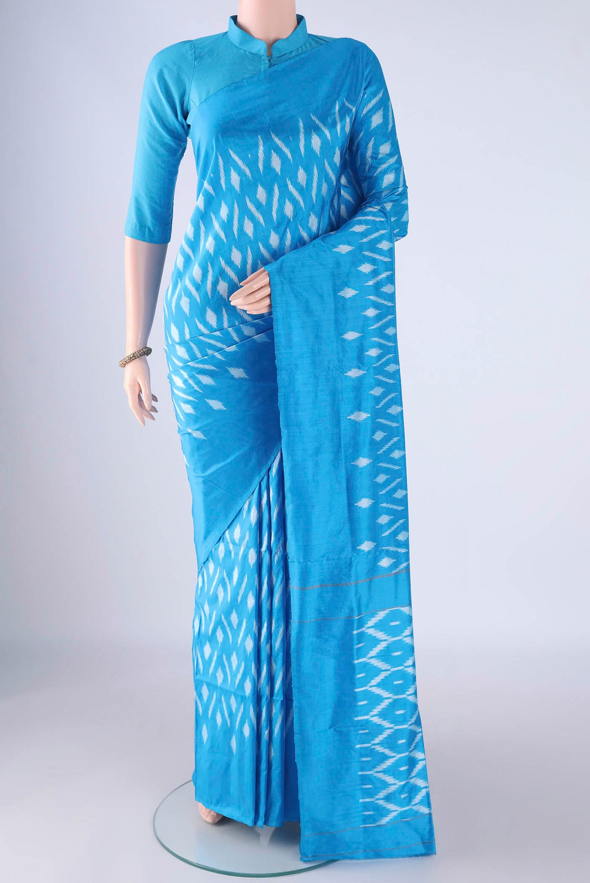 Sky Blue Pochampally Silk Saree with Pure Ikat on the body and Plain Border.  displayed on a mannequin