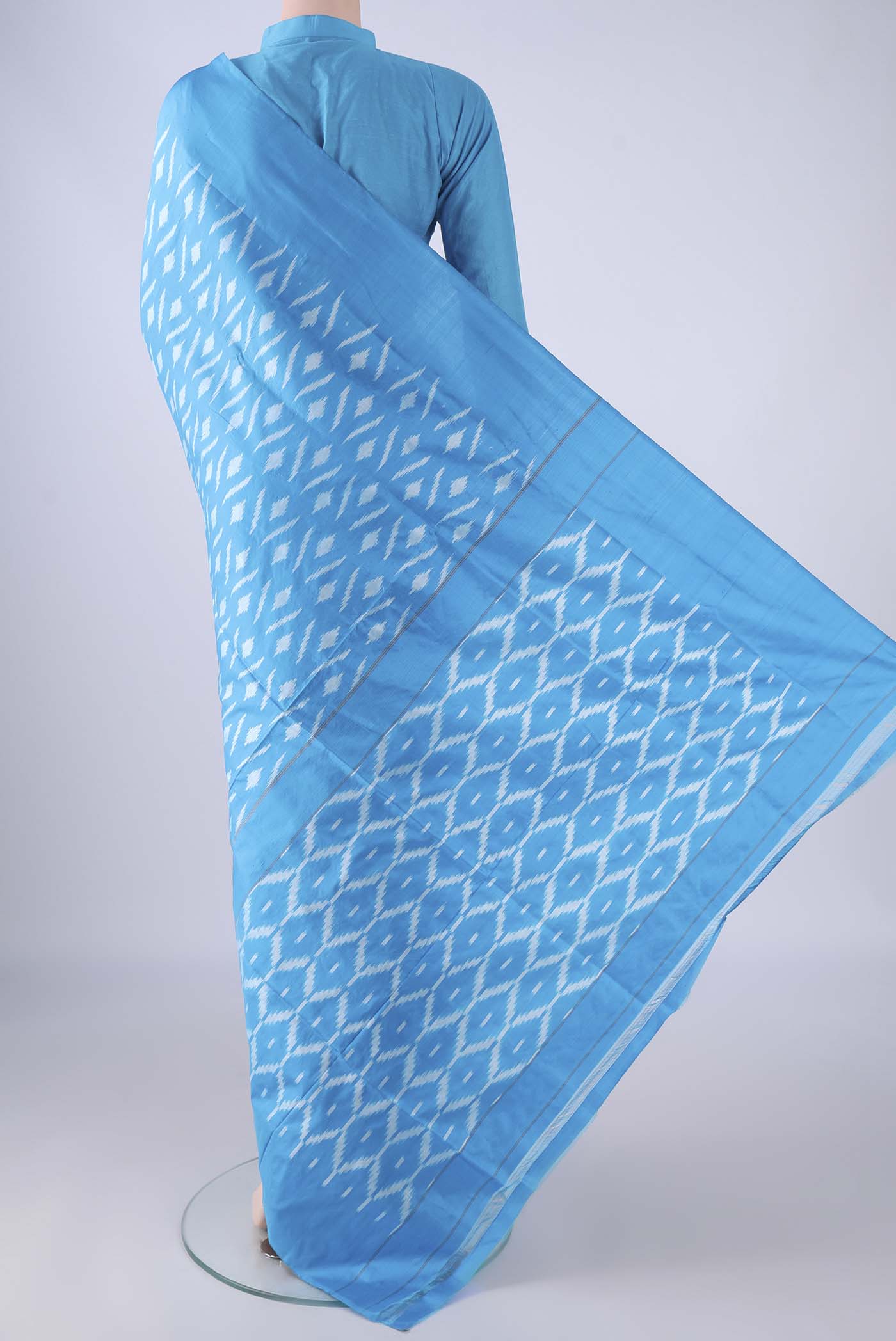 Flat view of Sky Blue Pochampally Silk Saree with Pure Ikat on the body and Plain Border. 
