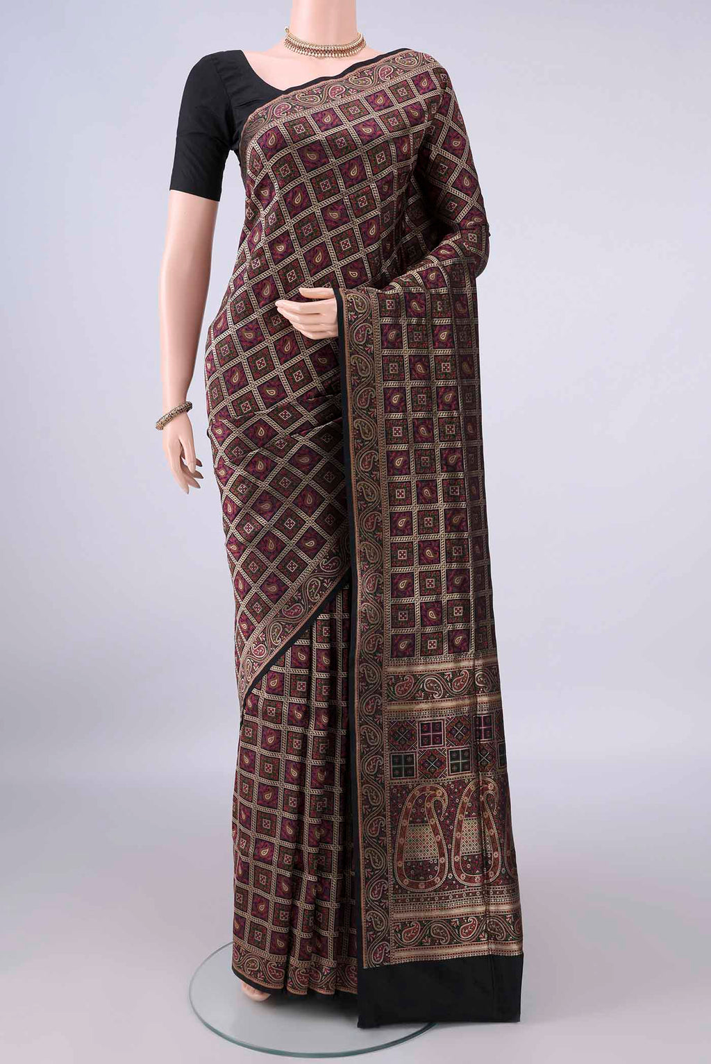 Pure Silk Black Banarasi Jamavar Saree with Checked design on the body and Zari Border.  displayed on a mannequin