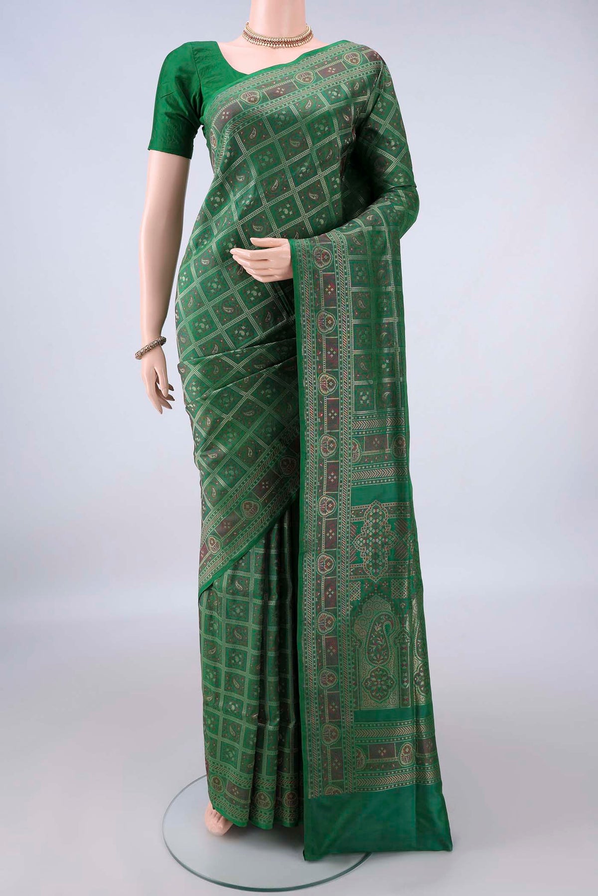 Pure Silk Bottle Green Banarasi Jamavar Saree with Checked design on the body and Zari Border.  displayed on a mannequin