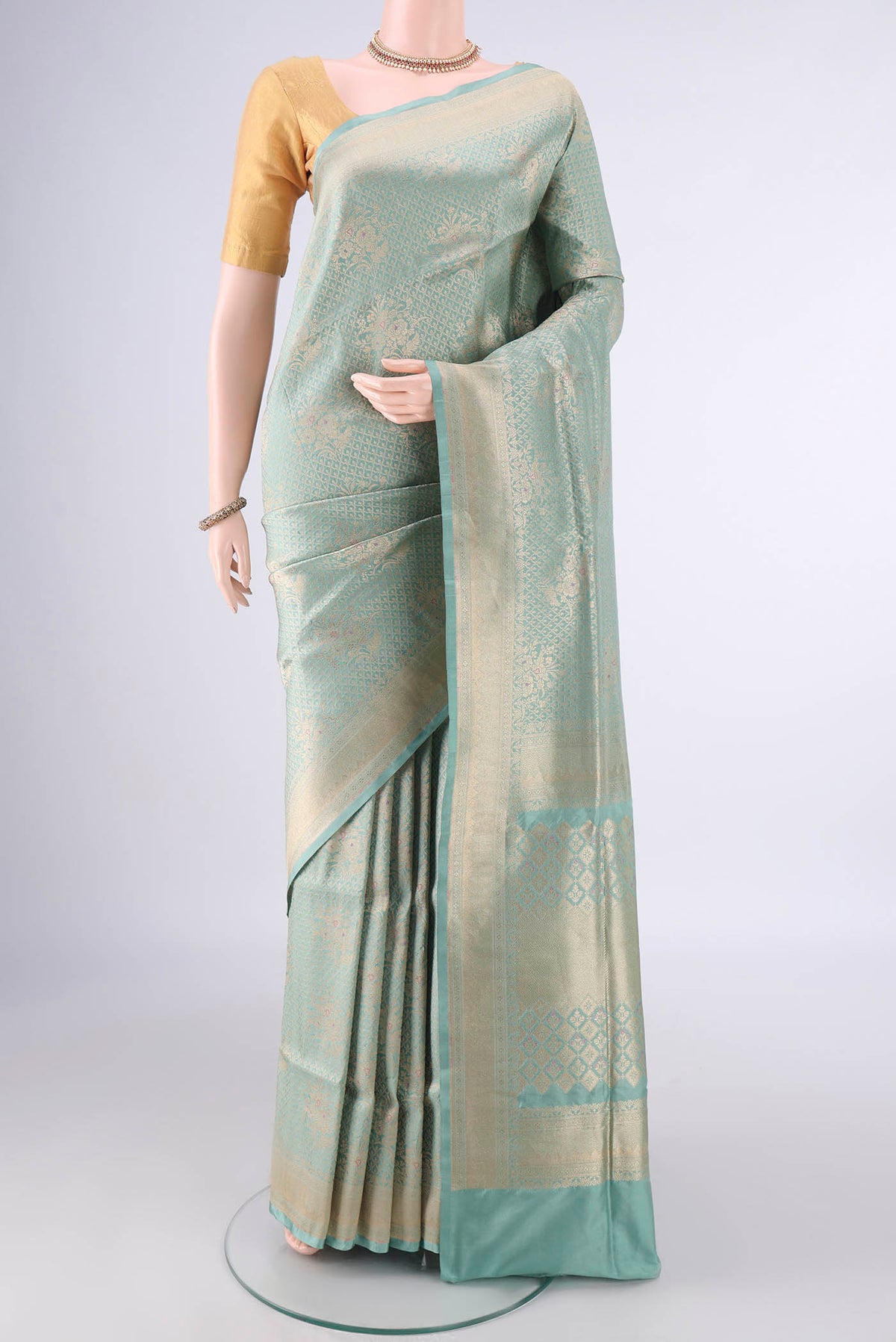 Pure Silk Light Green Banarasi Saree with Zari Brocade on the body and Zari Border.  displayed on a mannequin
