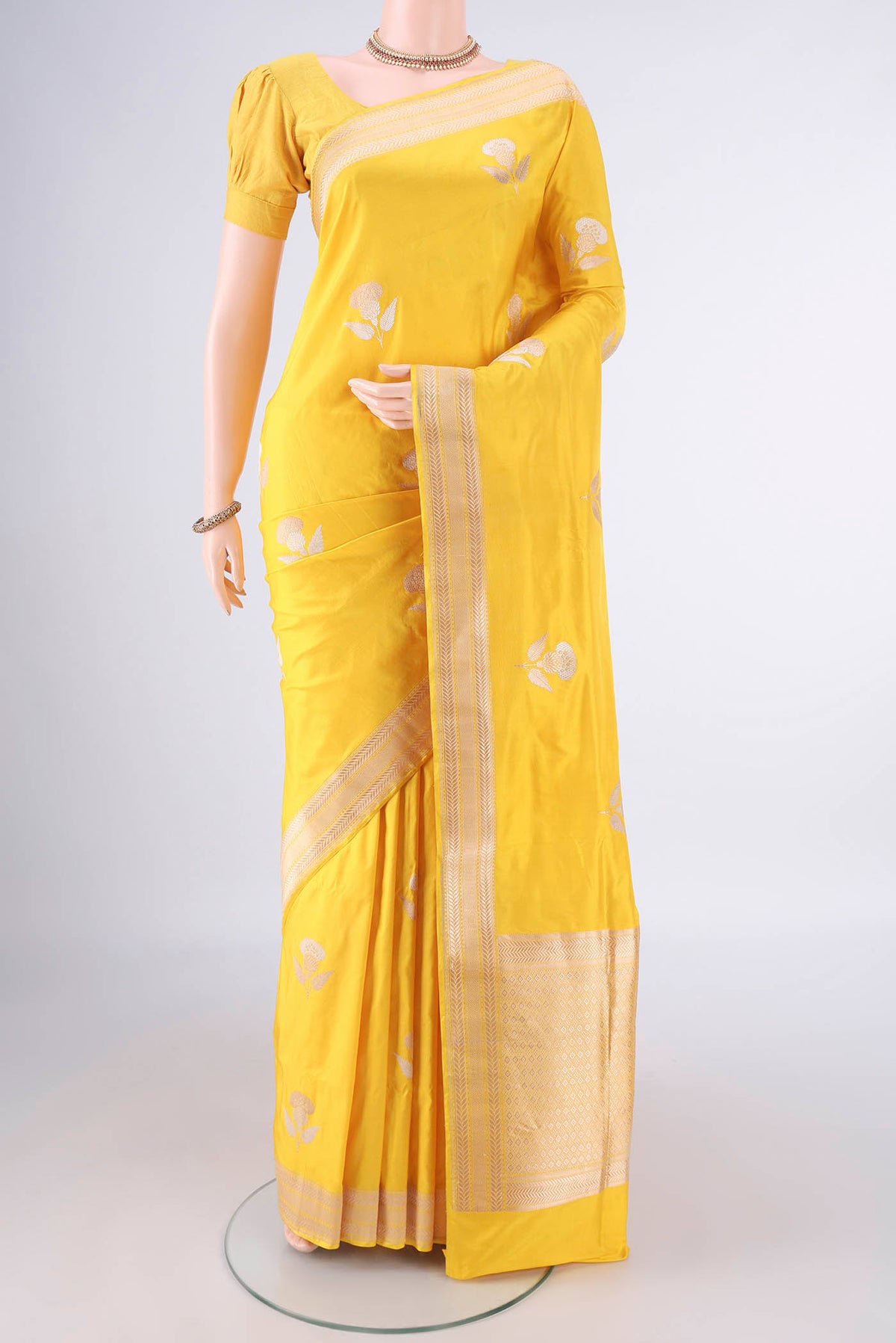 Pure Silk Yellow Banarasi Saree with Zari Butta on the body and Zari Border.  displayed on a mannequin