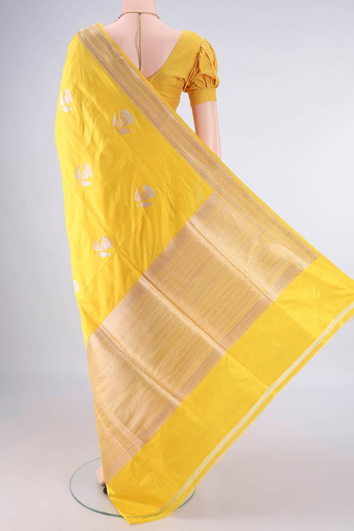 Flat view of Pure Silk Yellow Banarasi Saree with Zari Butta on the body and Zari Border. 