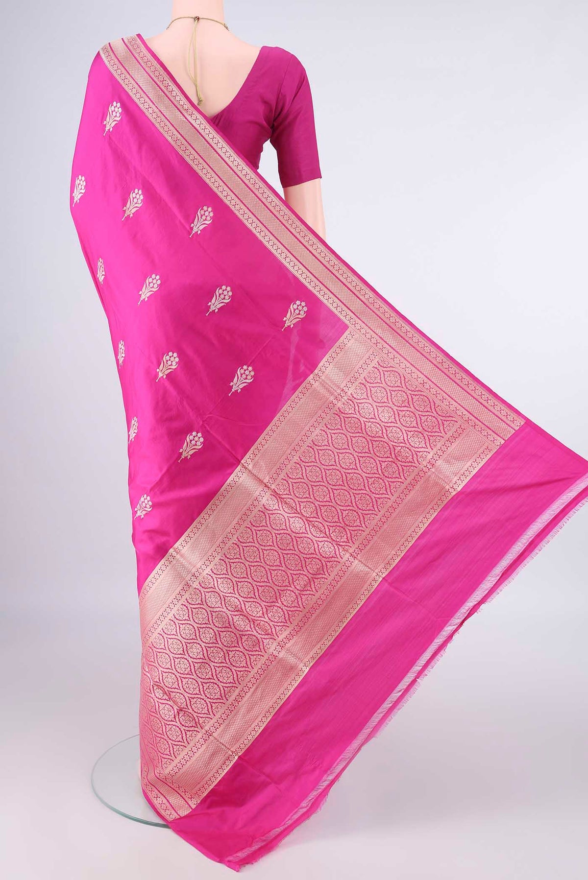 Flat view of Pure Silk Rani Pink Banarasi Saree with Zari Butta on the body and Zari Border. 
