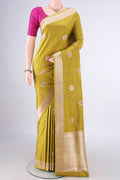 Pure Silk Mehandi Green Banarasi Saree with Zari Butta on the body and Zari Border.  displayed on a mannequin
