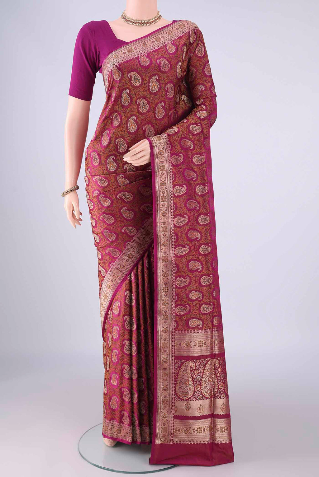 Magenta Banarasi Tanchoi Silk Saree with Jacquard With Thread Butta on the body and Zari And Thread Border.  displayed on a mannequin