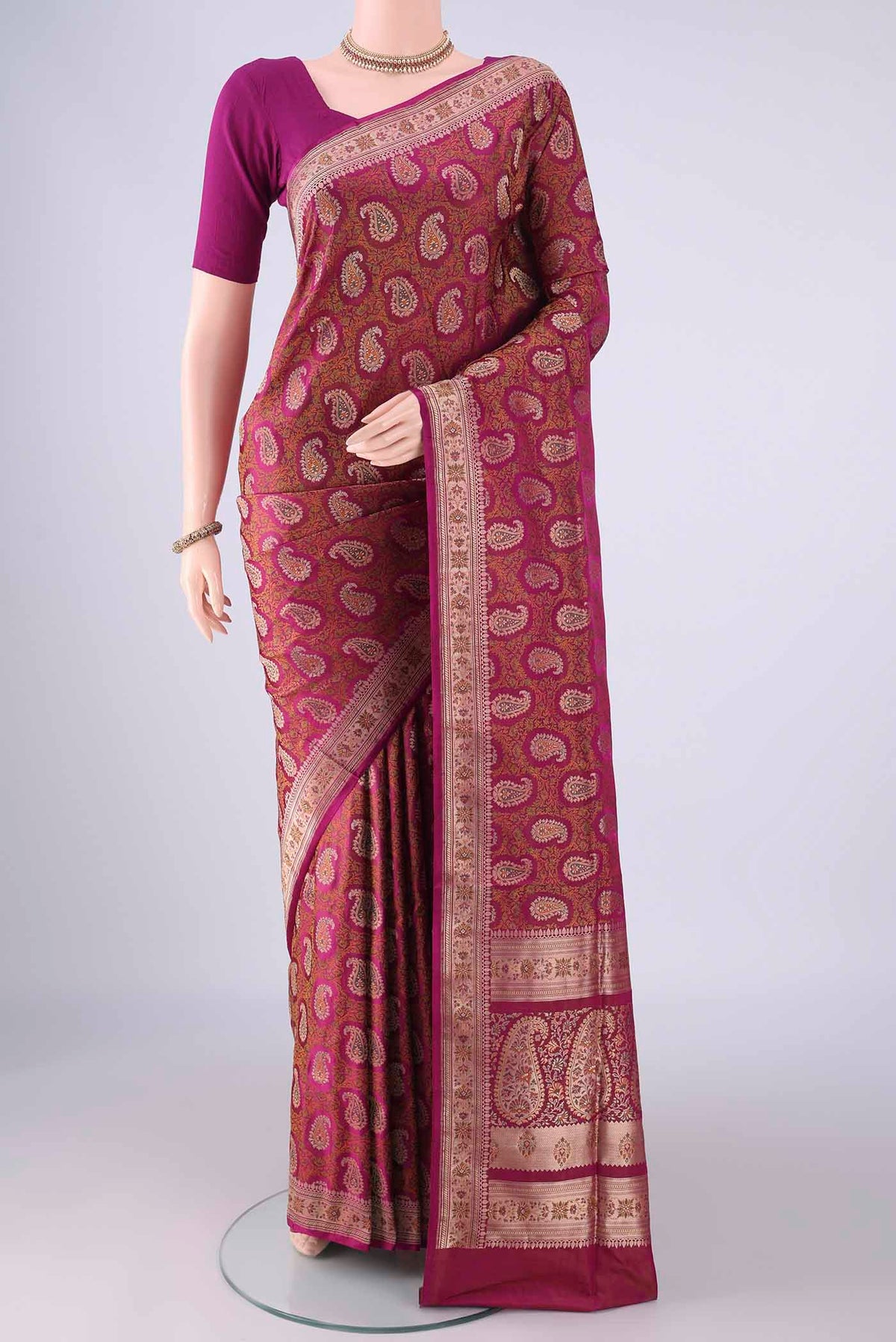 Magenta Banarasi Tanchoi Silk Saree with Jacquard With Thread Butta on the body and Zari And Thread Border.  displayed on a mannequin