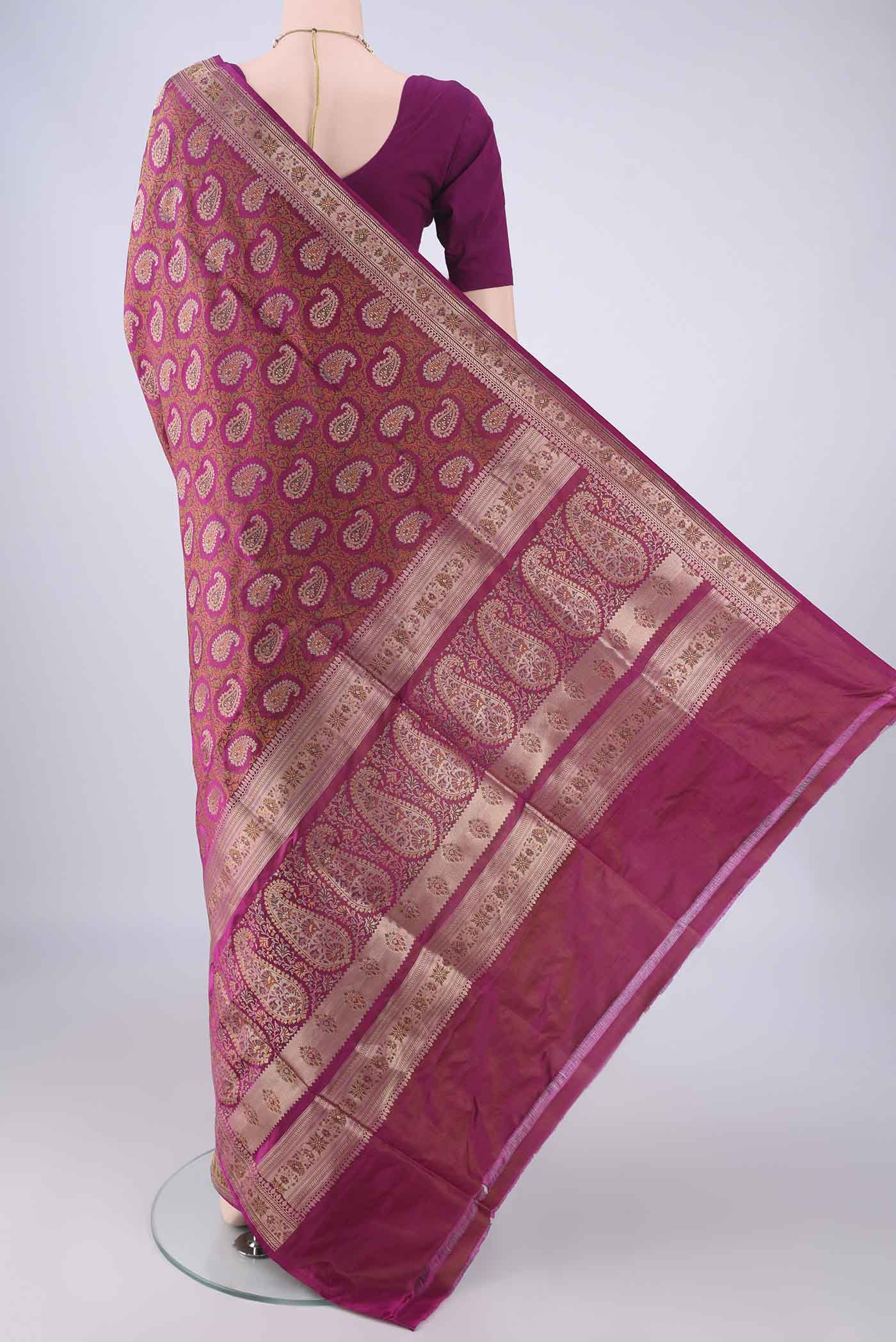 Flat view of Magenta Banarasi Tanchoi Silk Saree with Jacquard With Thread Butta on the body and Zari And Thread Border. 