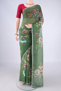 Green Linen Saree with Floral Print on the body and Zari Border.  displayed on a mannequin