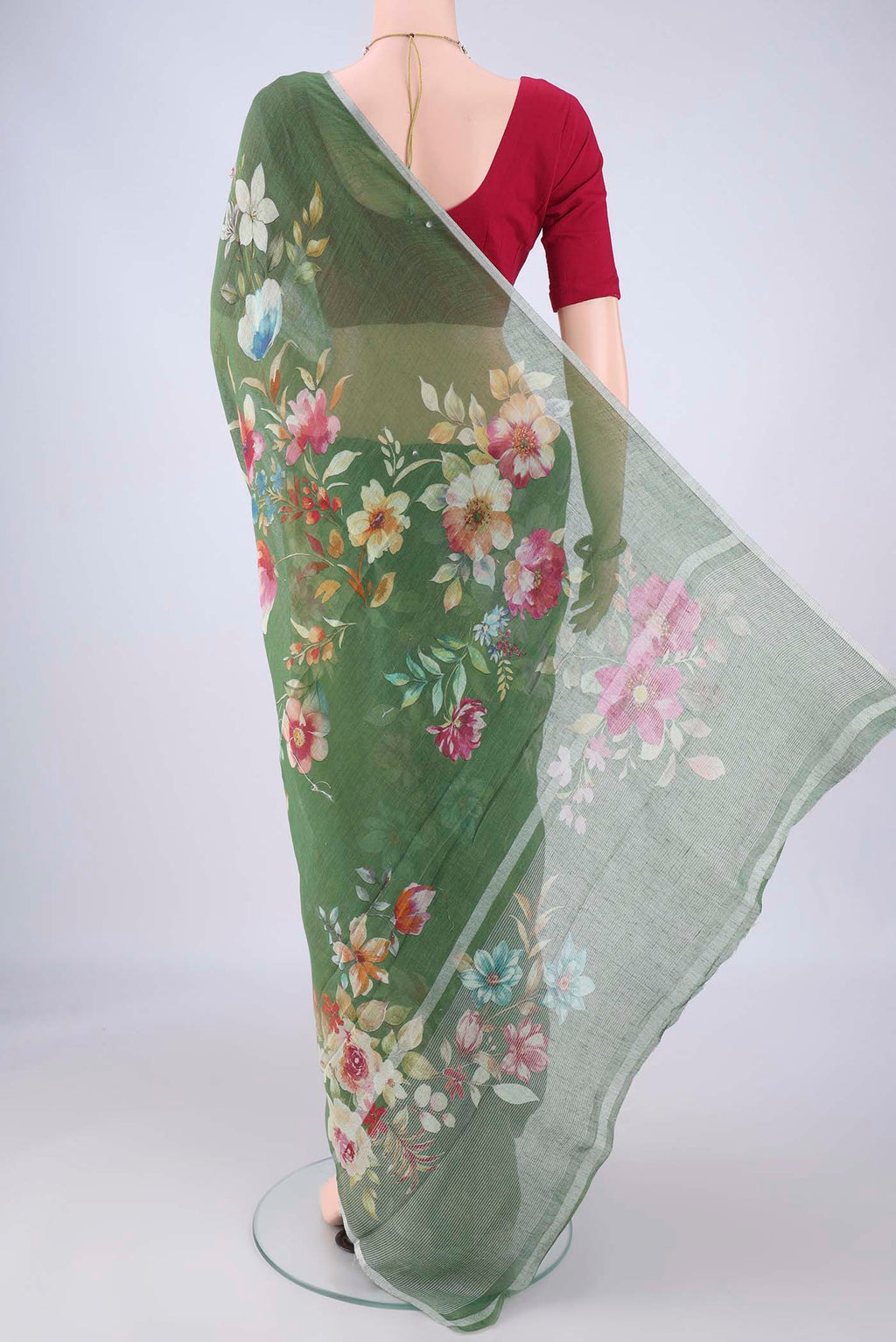 Flat view of Green Linen Saree with Floral Print on the body and Zari Border. 
